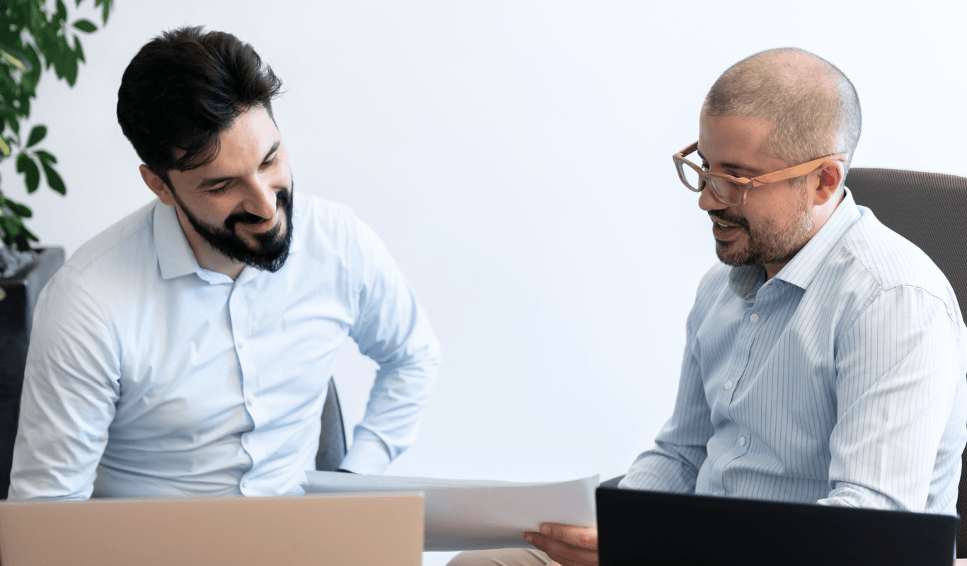 Two beautiful men discussing new project approach in the office