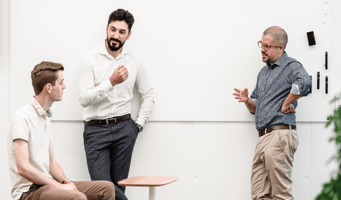 Our team discussing future sprint near the wall at the office