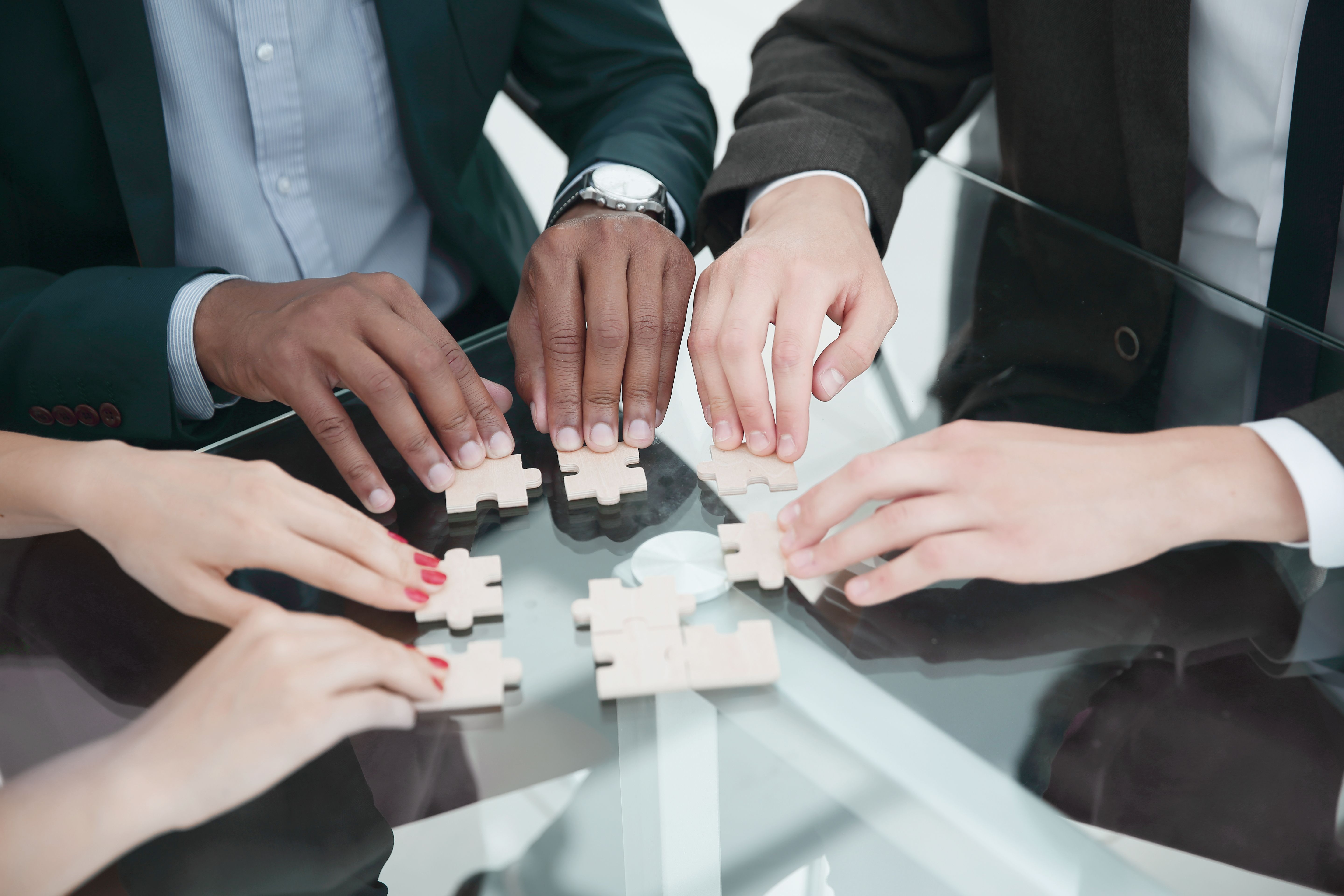 closeup-multinational-business-team-assembling-puzzle-concept-strategy-business.jpg