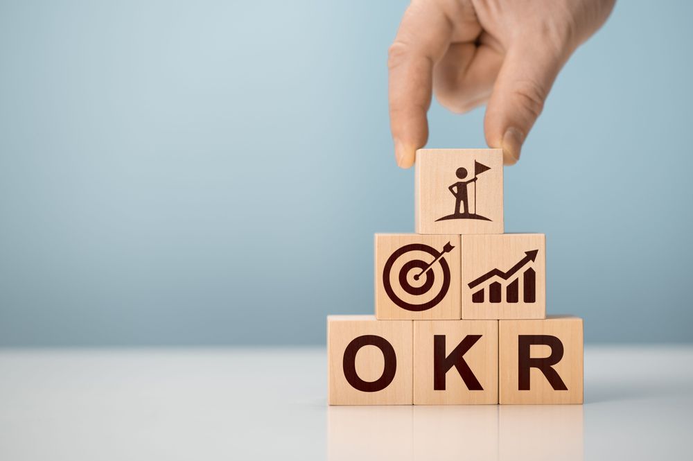 okr-objectives-key-results-wooden-cube-blocks-blue-background-business-target-drive-business-performance-business-okr-objectives-key-results-concept.